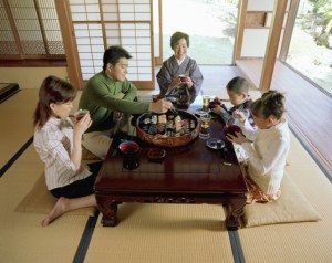 a family eating at the table and respecting Japanese tradition