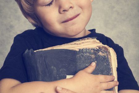 Contradictions in the Bible, boy hugging book.
